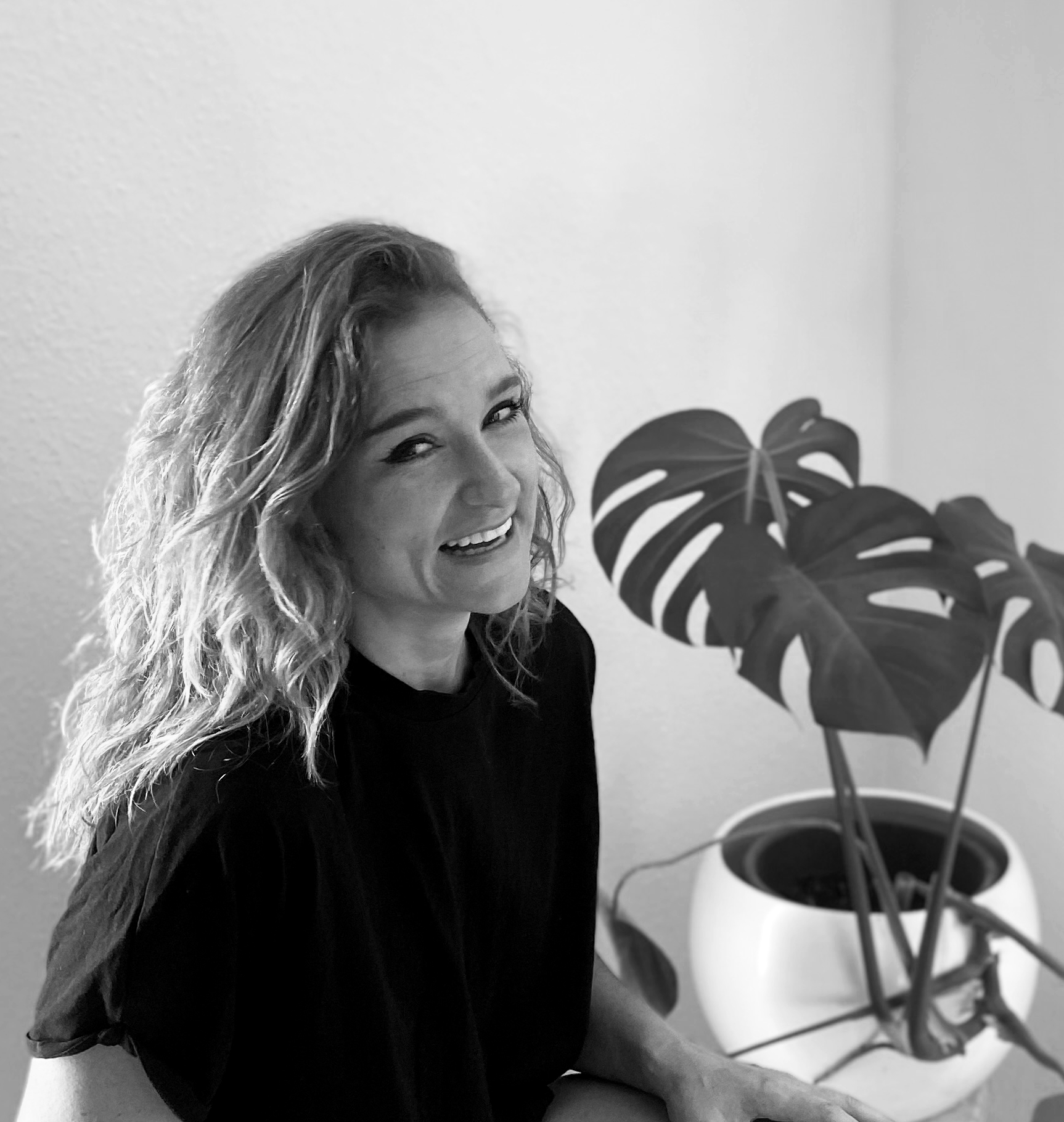 B/W portrait of the inventor in the office in front of a potted plant.