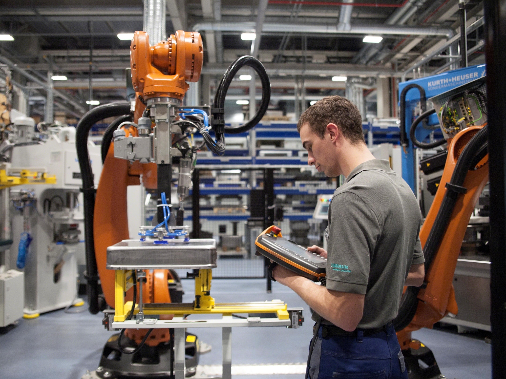 Man standing in front of a robot.