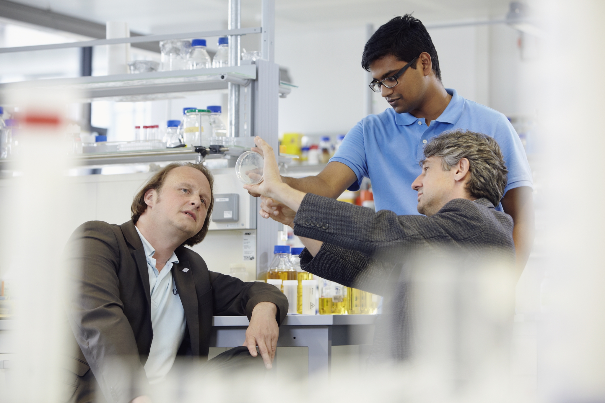 Two scientists talking with each other.